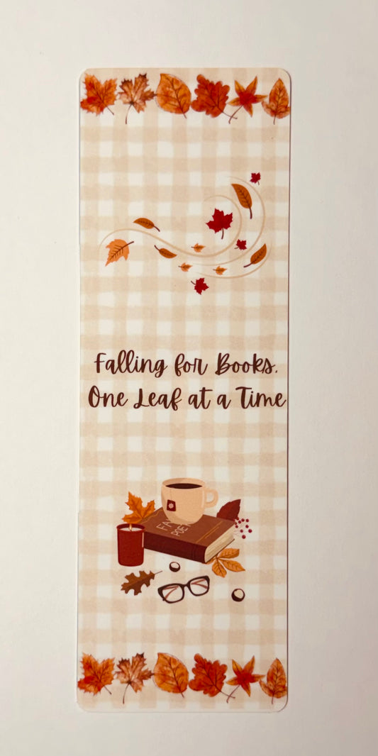 Bookmark with autumn leaves that says "Falling for books. One Leaf at a Time"  on a gingham background